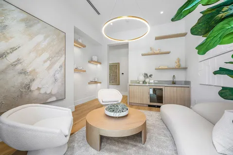 a front view of a house with a yard and potted plants