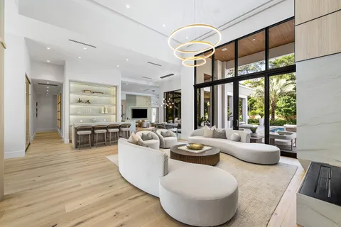 a view of a house with swimming pool and sitting area