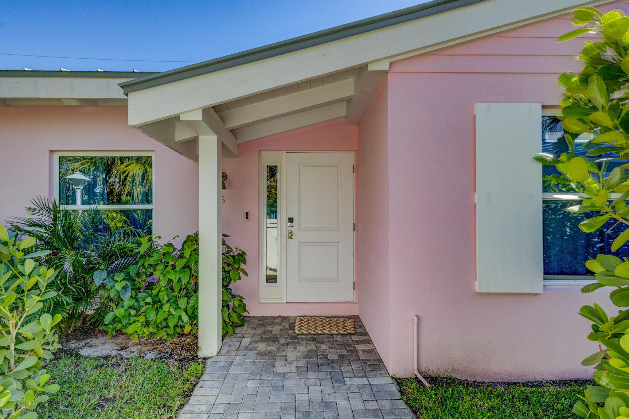240 Celestial Way, Unit 5 Juno Beach, FL 33408 - Photo 20 of 41 a front view of a house with a yard