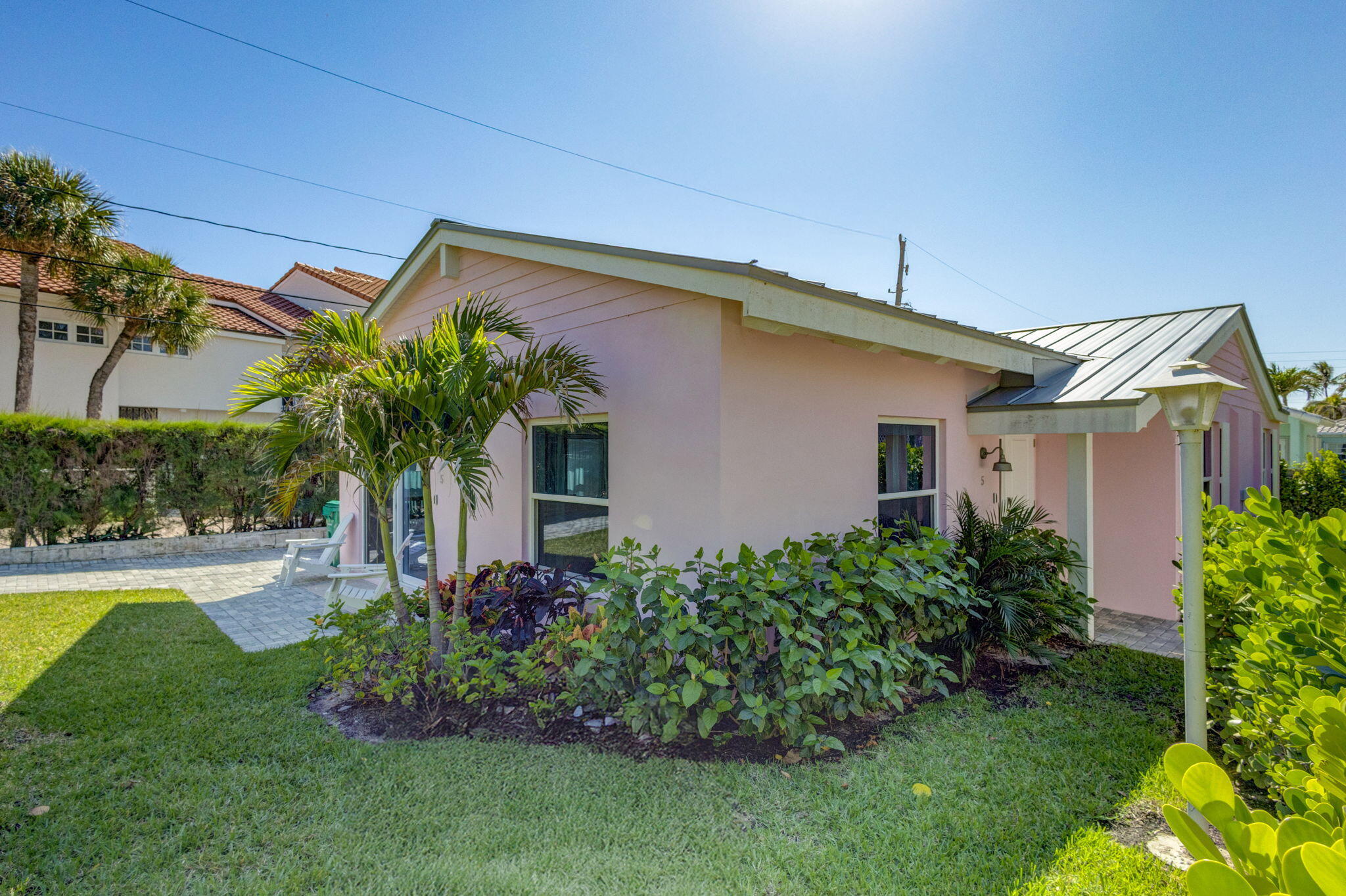 240 Celestial Way, Unit 5 Juno Beach, FL 33408 - Photo 22 of 41 a front view of a house with garden