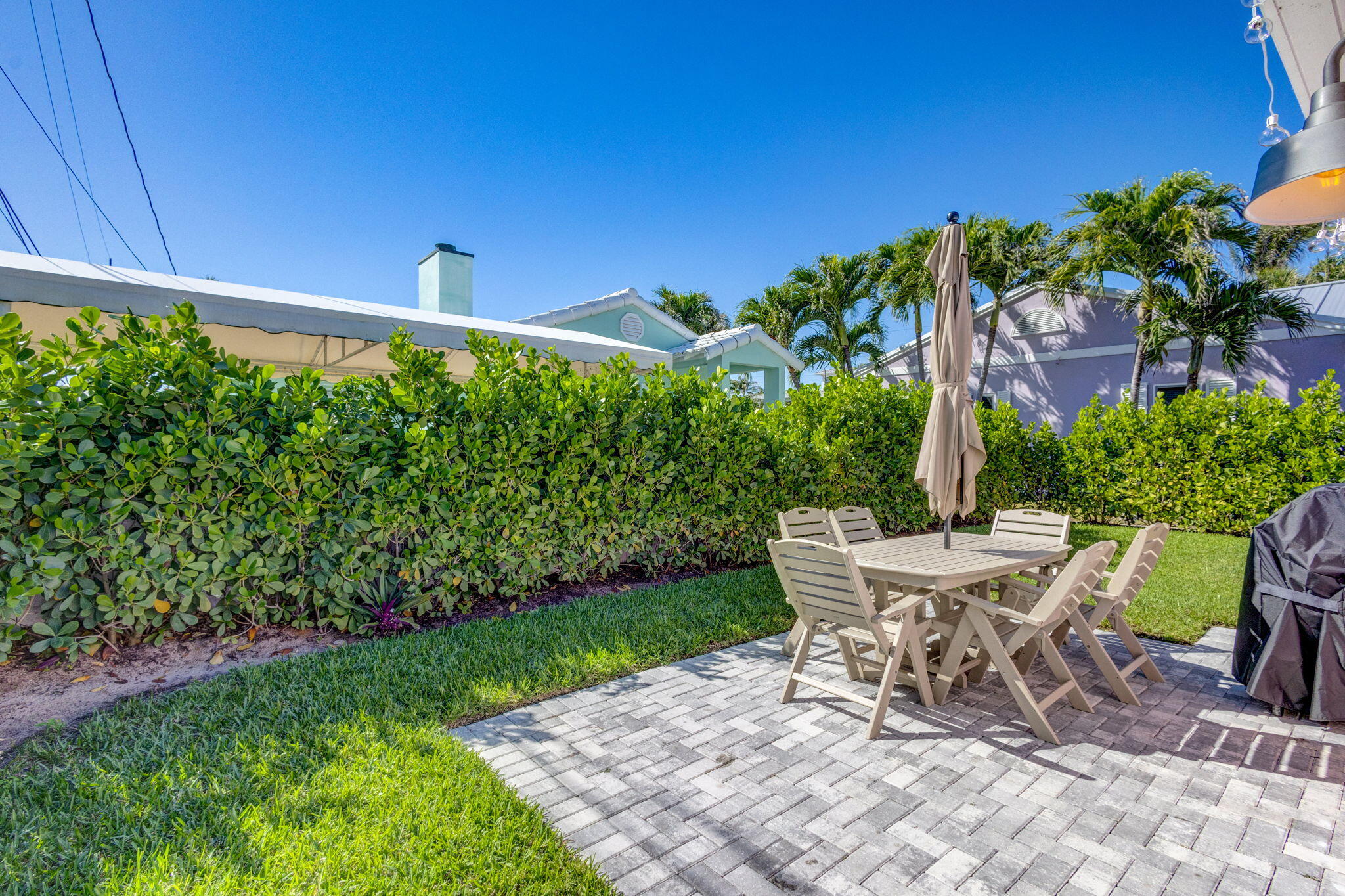 240 Celestial Way, Unit 5 Juno Beach, FL 33408 - Photo 23 of 41 a view of a backyard with plants and a patio