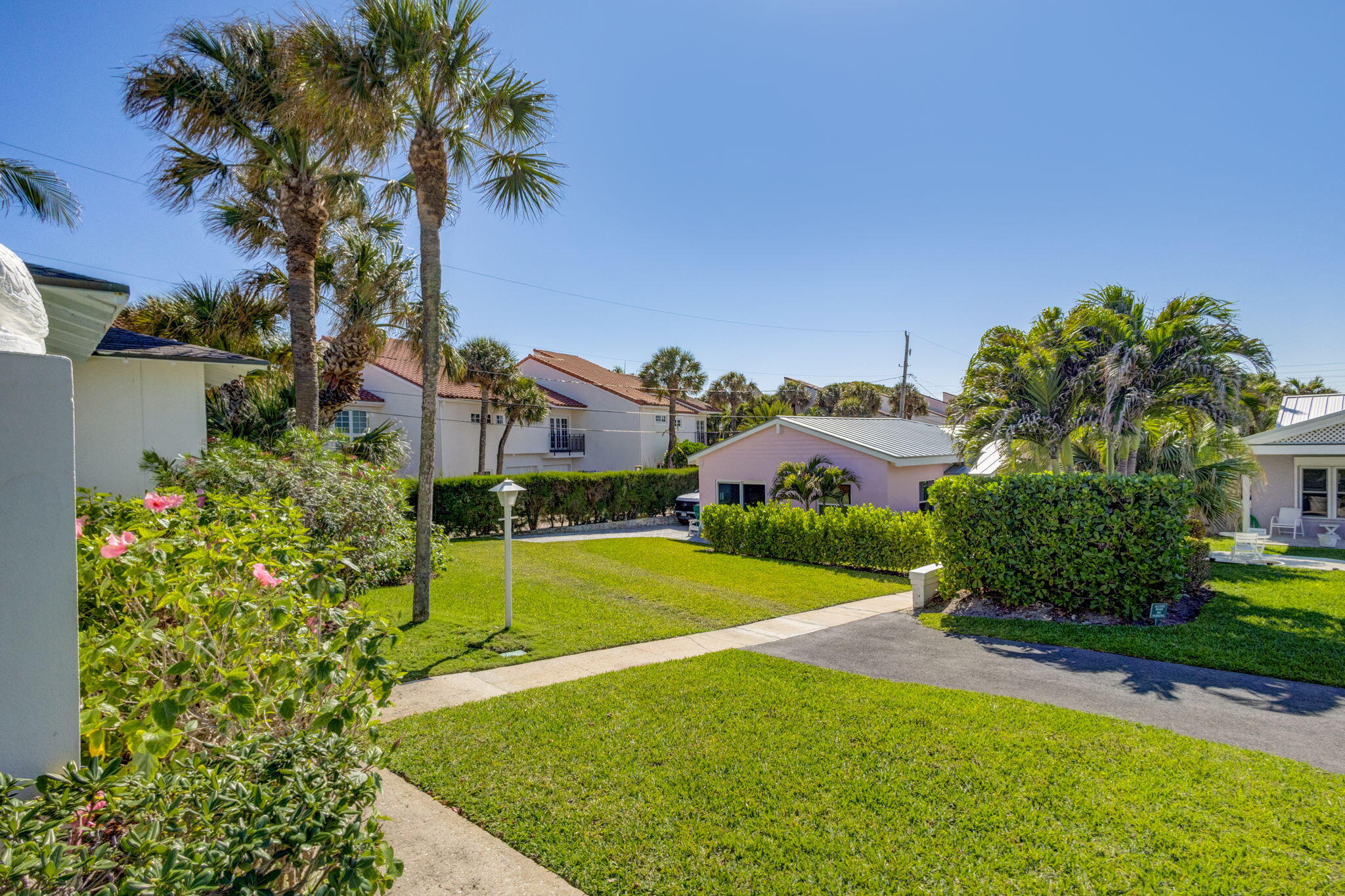 240 Celestial Way, Unit 5 Juno Beach, FL 33408 - Photo 24 of 41 a view of a big yard with palm trees