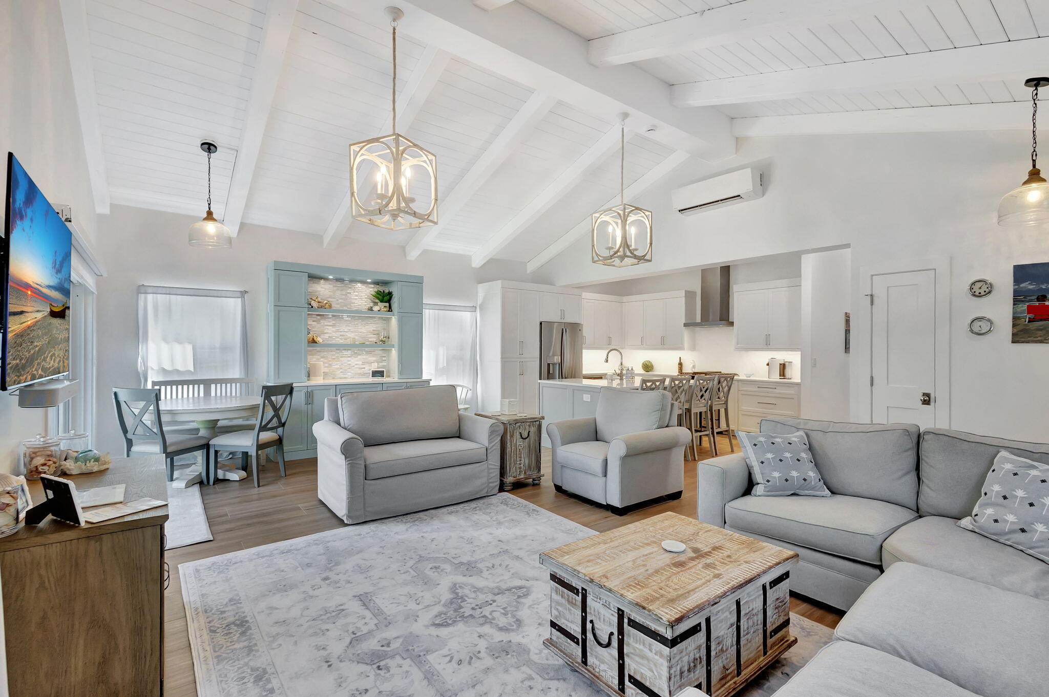 240 Celestial Way, Unit 5 Juno Beach, FL 33408 - Photo 5 of 41 a living room with furniture kitchen view and a chandelier