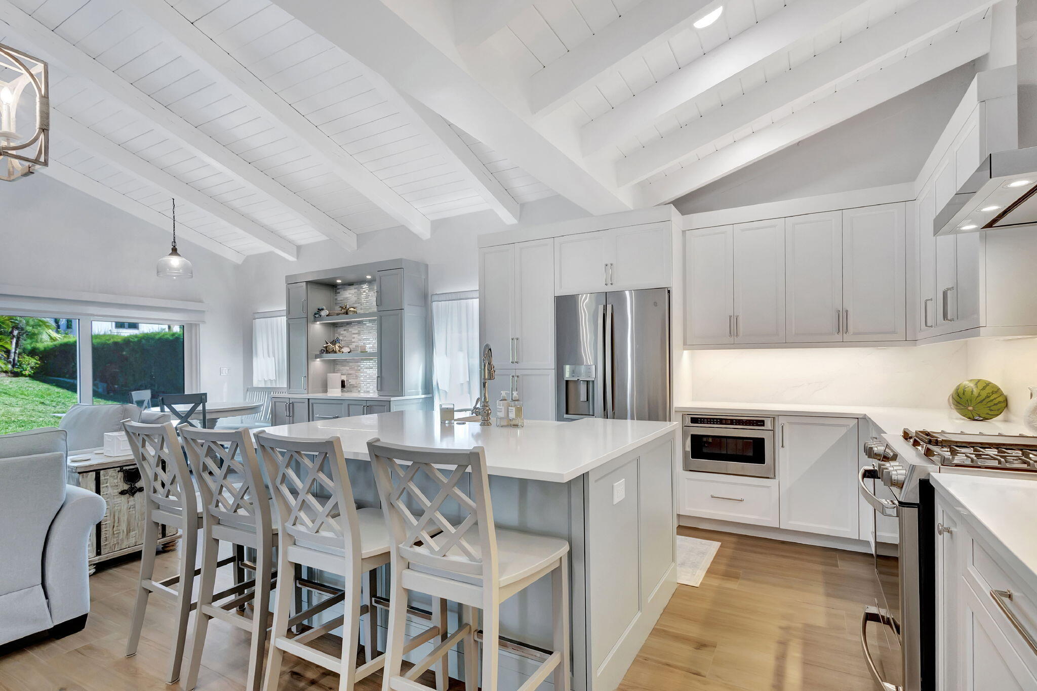 240 Celestial Way, Unit 5 Juno Beach, FL 33408 - Photo 8 of 41 a kitchen with a table chairs refrigerator and cabinets