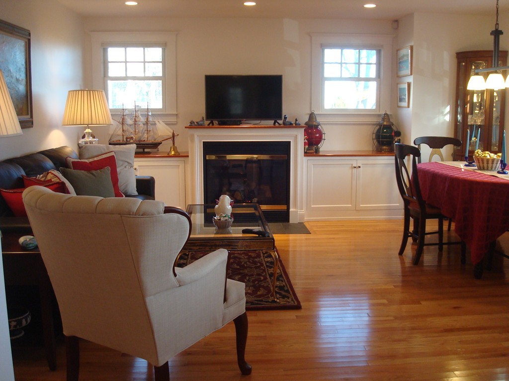 14 Atlantic Road, Unit 5 Gloucester, MA 01930 - Photo 3 of 17 a living room with furniture a flat screen tv and a fireplace