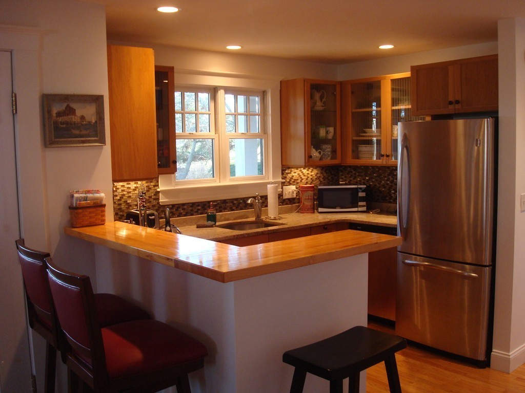 14 Atlantic Road, Unit 5 Gloucester, MA 01930 - Photo 7 of 17 a kitchen with stainless steel appliances granite countertop a refrigerator a stove and a sink