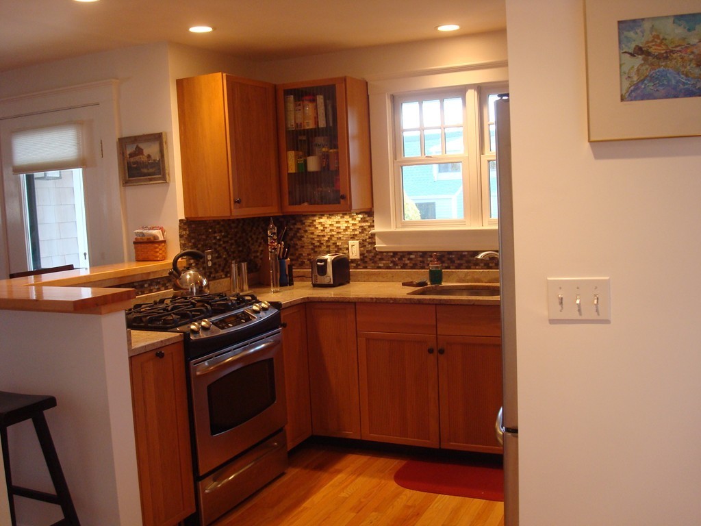 14 Atlantic Road, Unit 5 Gloucester, MA 01930 - Photo 8 of 17 a kitchen with stainless steel appliances granite countertop a stove a sink and a microwave