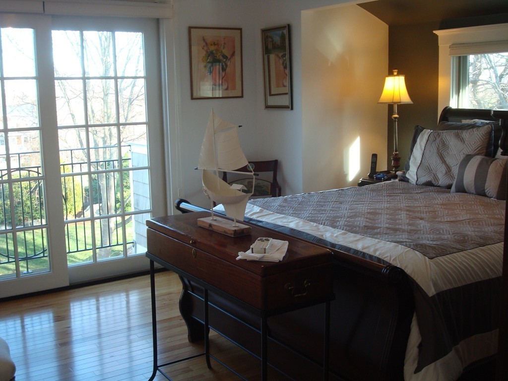 14 Atlantic Road, Unit 5 Gloucester, MA 01930 - Photo 9 of 17 a bed sitting in a bedroom next to a window