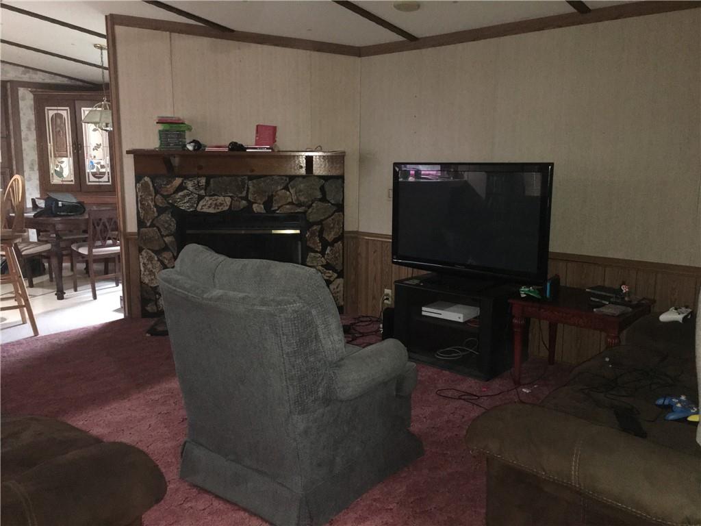 417 Red Mill Road Kittanning, PA 16201 - Photo 13 of 18 a living room with furniture a flat screen tv and a floor to ceiling window