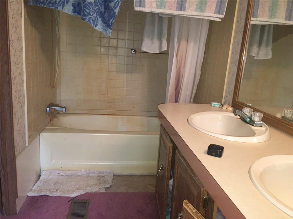417 Red Mill Road Kittanning, PA 16201 - Photo 7 of 18 a bathroom with a sink a bathtub and shower