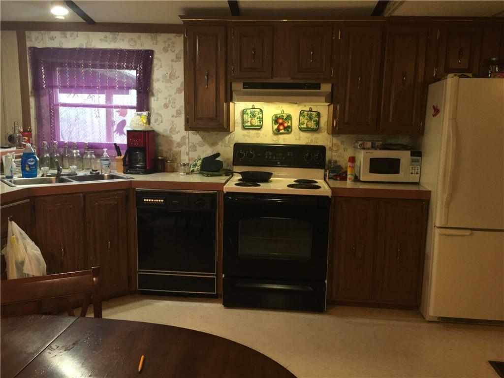 417 Red Mill Road Kittanning, PA 16201 - Photo 9 of 18 a kitchen with stainless steel appliances a stove a refrigerator and a sink