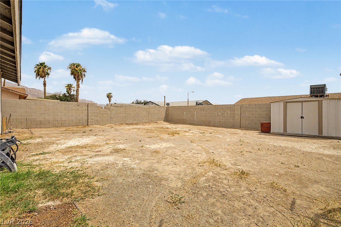 5357 Indian Wells Road Las Vegas, NV 89110 - Photo 37 of 39 A spacious backyard with block wall fencing offers a blank canvas for outdoor living design.