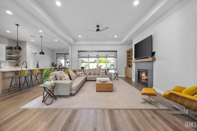 a living room with furniture a flat screen tv and a fireplace
