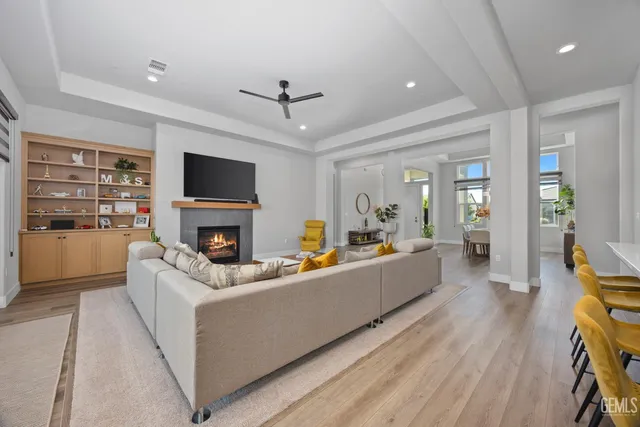 a kitchen with stainless steel appliances kitchen island granite countertop a table chairs sink and cabinets
