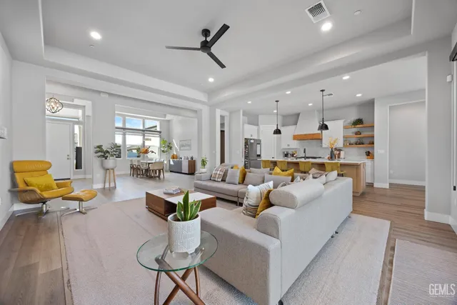 a kitchen with stainless steel appliances granite countertop white cabinets and a stove