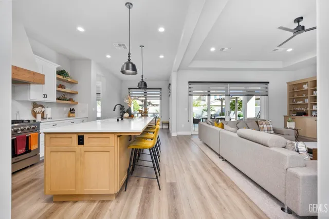 a kitchen with stainless steel appliances granite countertop a sink a stove and a refrigerator