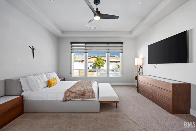 a spacious bedroom with a bed and a window