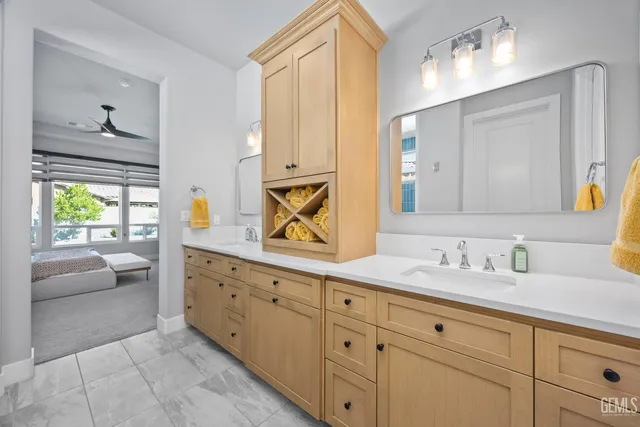 a bathroom with a granite countertop sink mirror vanity and toilet