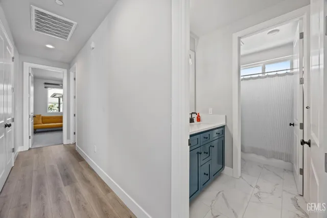 a view of a dining room with furniture and a potted plant