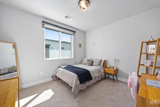 a view of a white house with a swimming pool and sitting area