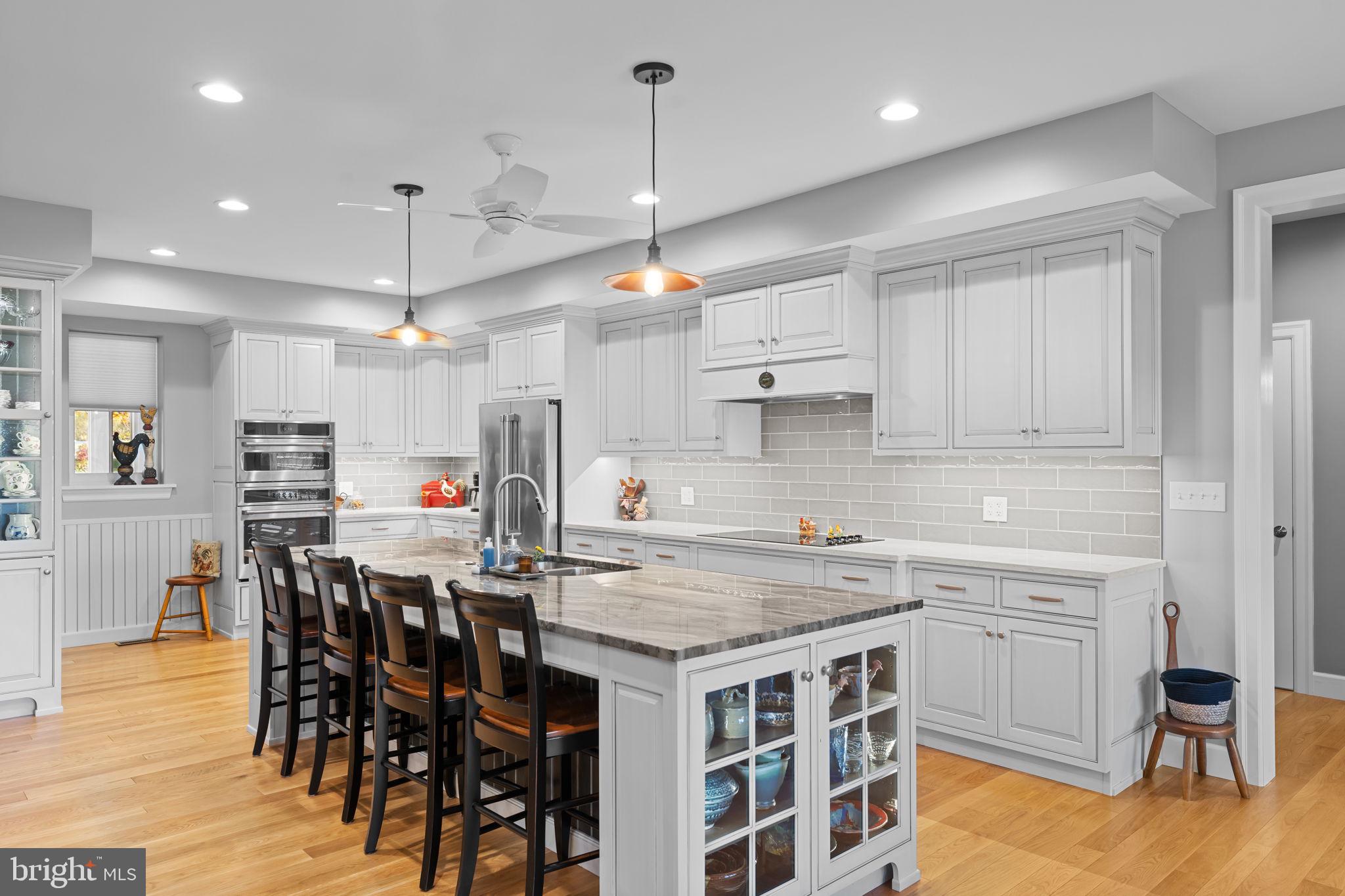 675 West Seven Stars Road Phoenixville, PA 19460 - Photo 14 of 45 a kitchen that has a lot of cabinets in it and wooden floors