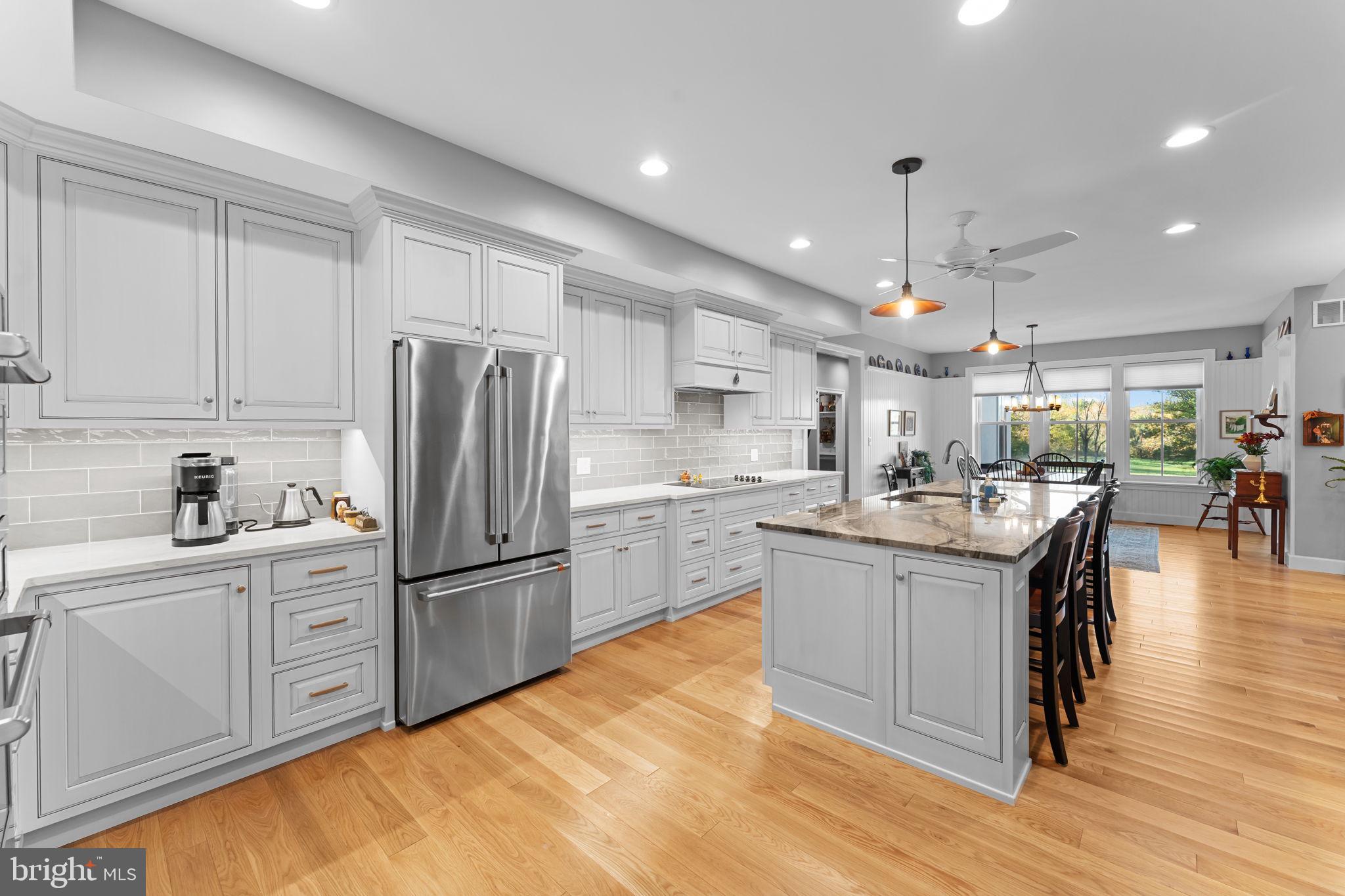 675 West Seven Stars Road Phoenixville, PA 19460 - Photo 17 of 45 a kitchen with stainless steel appliances granite countertop a refrigerator a sink dishwasher a stove and white cabinets with wooden floor