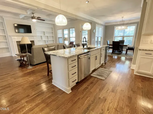 a dining room with wooden floor and breakfast area