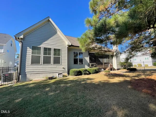 a bedroom with a bed and large window