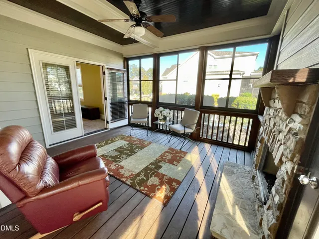 a living room with furniture fireplace and a large window