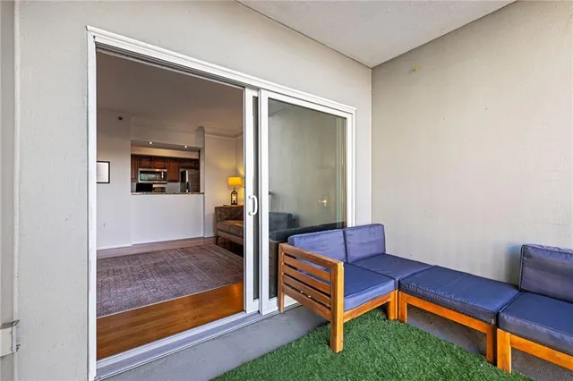 a bedroom with furniture and a large window