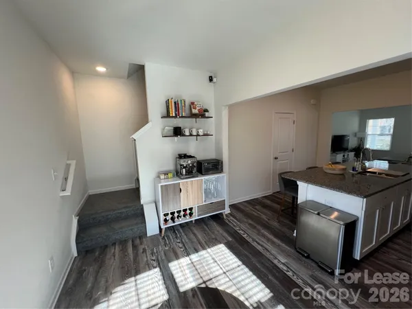 a living room with hard wood flooring and a couch