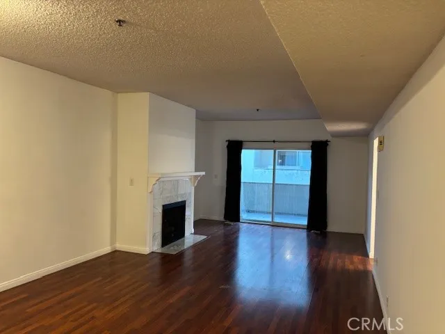 a view of a livingroom with wooden floor and a ceiling fan