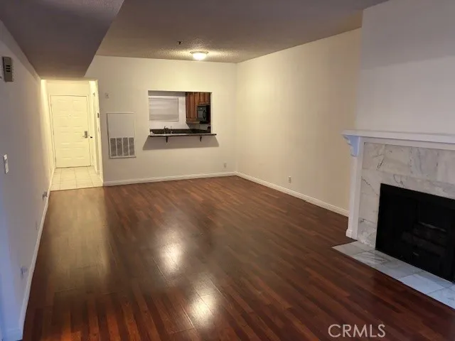a view of a room wooden floor and fire place