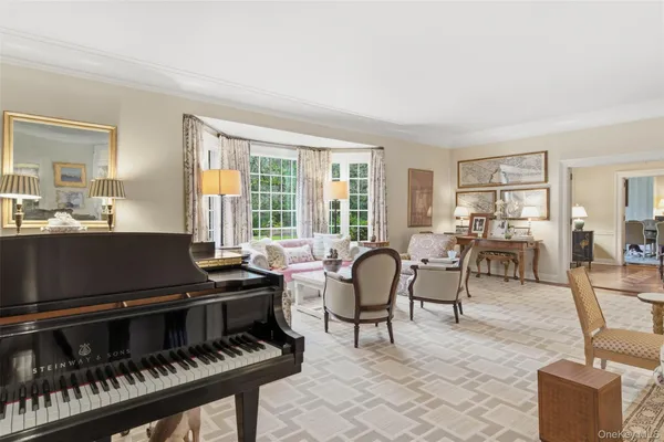 a living room with furniture and a piano