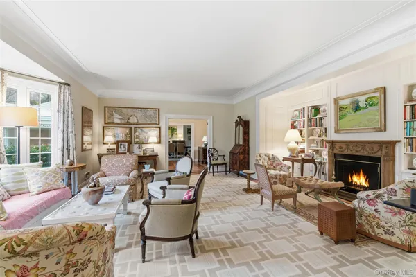 a living room with furniture large window and fireplace