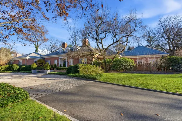 a front view of a house with a yard and pathway