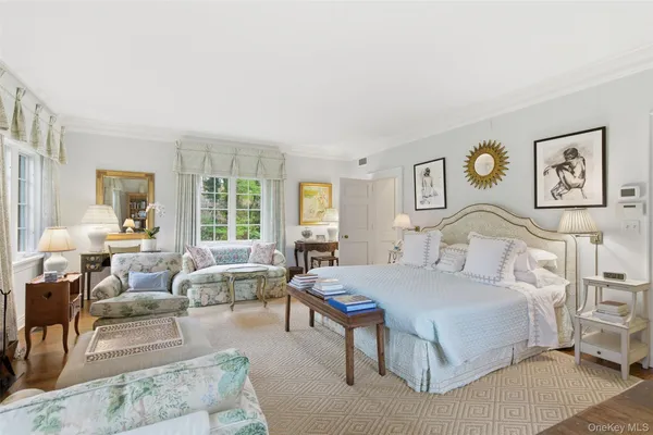 a spacious bedroom with a large bed couch and a window