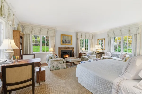 a living room with furniture large window and a fireplace