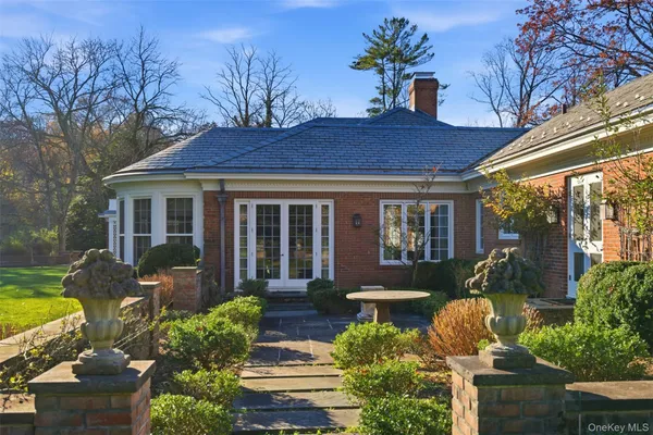 a front view of house with yard and outdoor seating