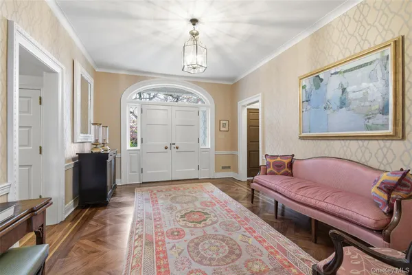 a spacious bedroom with a bed and a chandelier