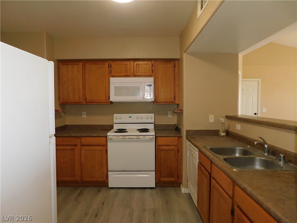 7255 West Sunset Road, Unit 2029 Las Vegas, NV 89113 - Photo 8 of 21 A well-appointed kitchen showcasing durable countertops and natural wood cabinetry for culinary tasks.