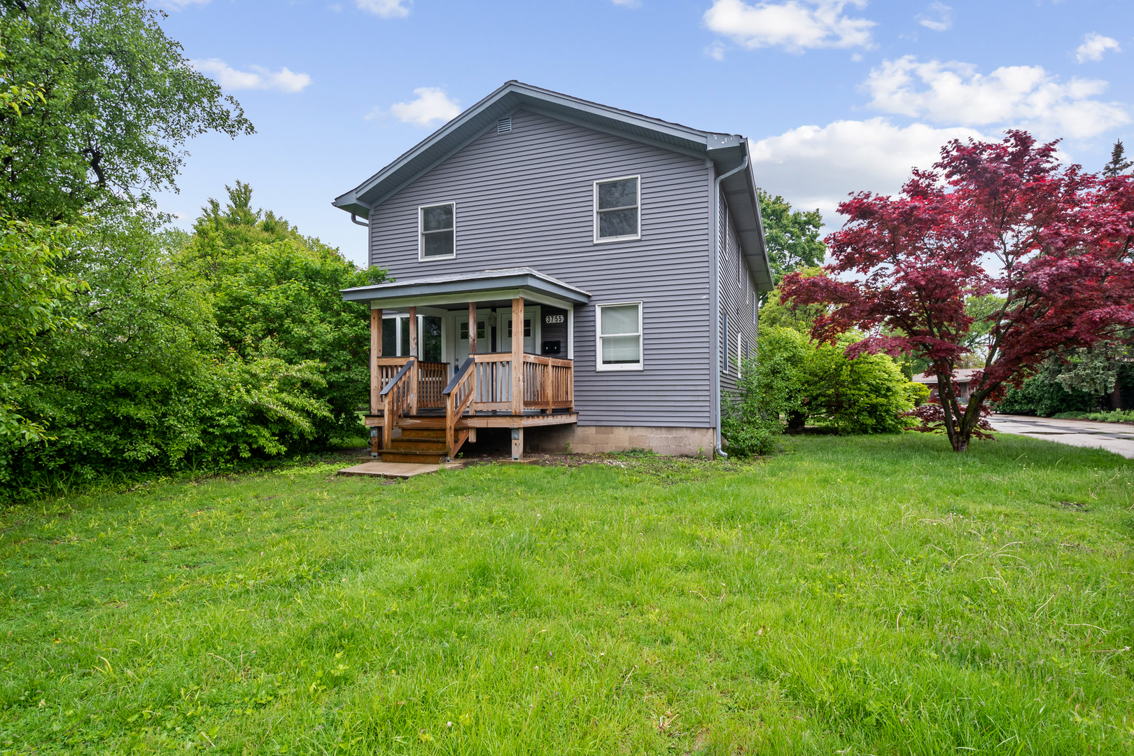 3755 Grove Street, Unit 1 Skokie, IL 60076 - Photo 1 of 24 a front view of a house with garden