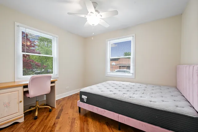 a bedroom with a bed and a chair