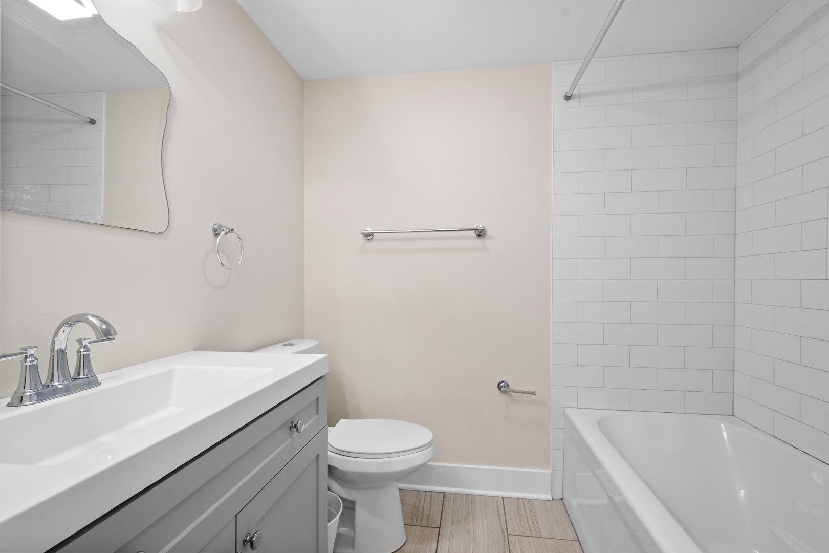 3755 Grove Street, Unit 1 Skokie, IL 60076 - Photo 16 of 24 a bathroom with a sink a toilet and shower