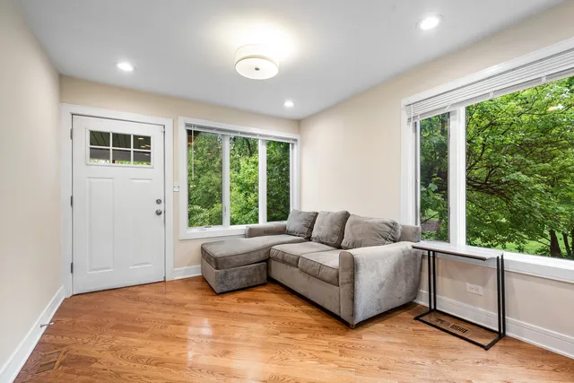 a living room with furniture and large windows