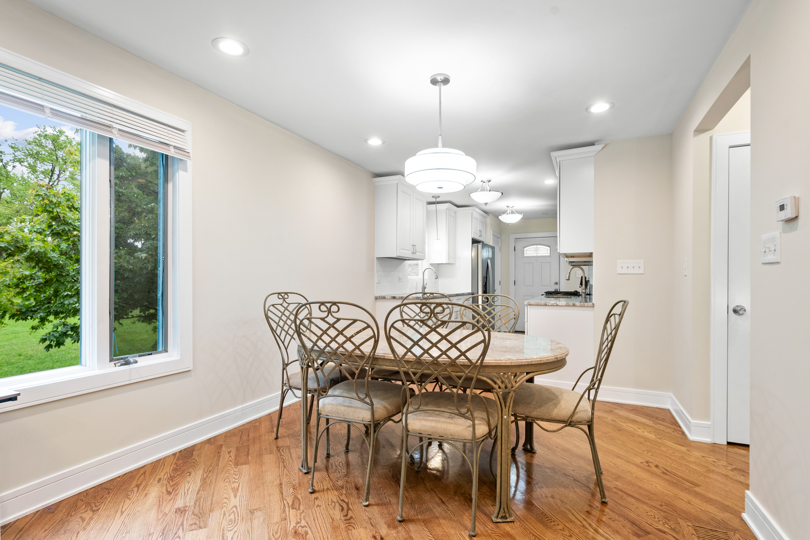 3755 Grove Street, Unit 1 Skokie, IL 60076 - Photo 5 of 24 a view of a dining room with furniture window and wooden floor