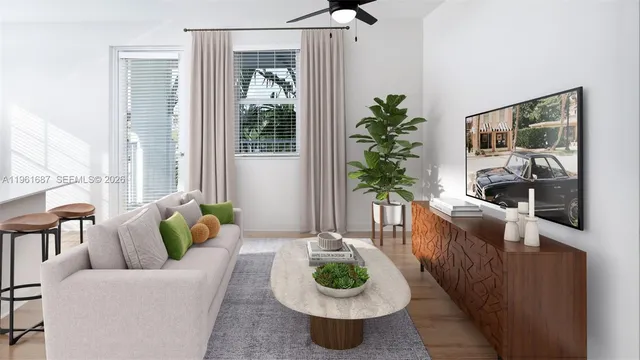 a living room with furniture and a potted plant