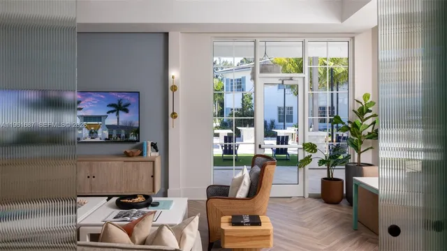 a living room with furniture and a potted plant