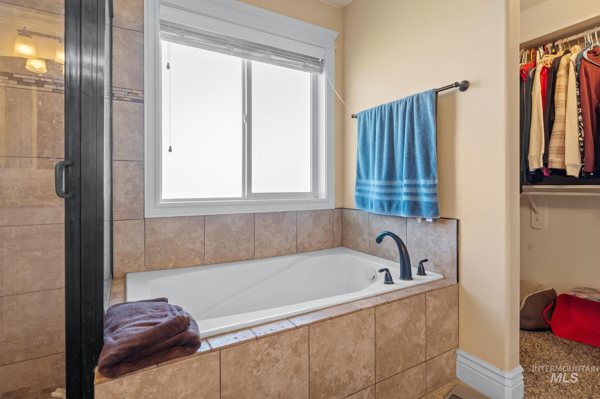 3625 North 2000 West Rexburg, ID 83440 - Photo 15 of 50 Full bath with a bath, a spacious closet, and a shower stall