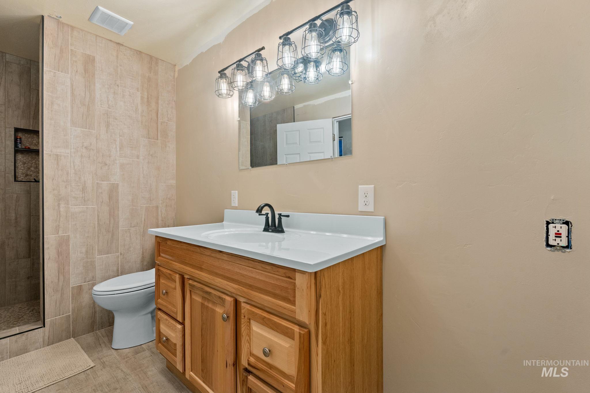 3625 North 2000 West Rexburg, ID 83440 - Photo 26 of 50 Bathroom featuring vanity and tiled shower